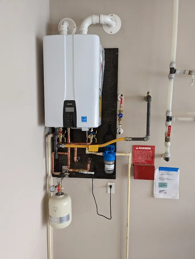 Professional plumber installing copper piping in a Orange home